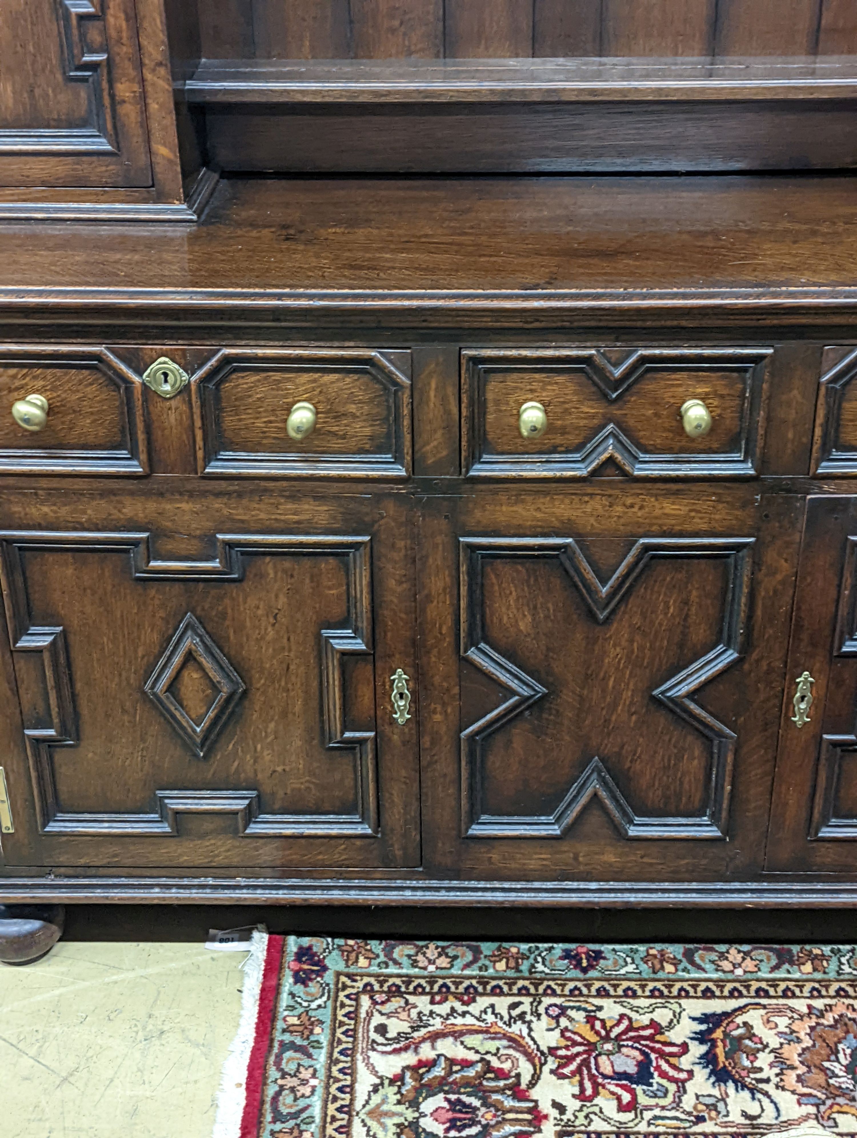 An early 20th century Jacobean revival oak dresser, width 168cm, depth 48cm, height 218cm